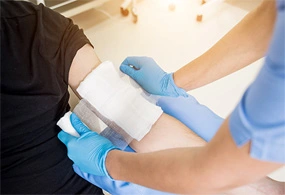 medical specialist applying bioengineered tissue therapy to foot at podiatrist in upland, ca